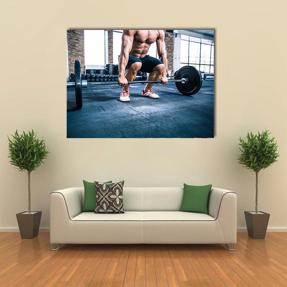 Muscular Man Lifting Weights Canvas Wall Art in black, gray and blue, single panel hung on a wall