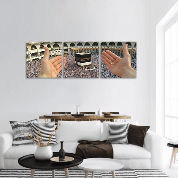 Man Praying at the Kaaba Panoramic Canvas Wall Art in black, white and gray, hung on a wall
