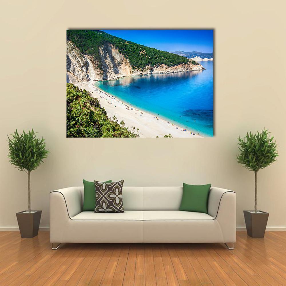 Myrtos Beach Cliffs and Turquoise Water Canvas Wall Art in white, green and blue, single panel hung on a wall