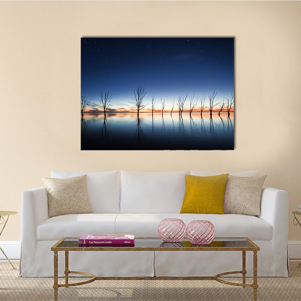 Mystic Lake at Dusk Canvas Wall Art in orange, blue and navy, single panel hung on a wall
