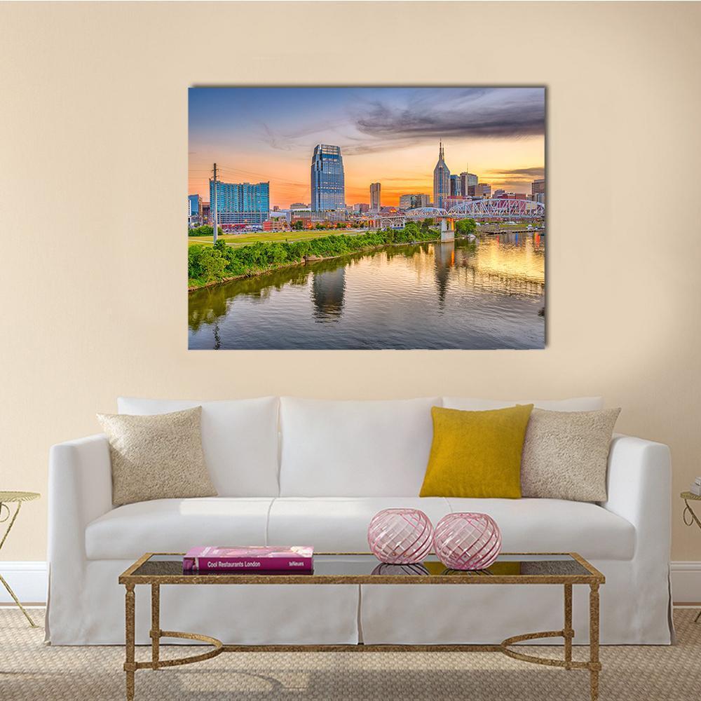 Nashville Riverfront Skyline at Golden Hour Canvas Wall Art in orange, yellow and blue, single panel hung on a wall