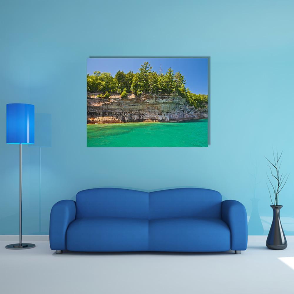 Pictured Rocks National Lakeshore Canvas Wall Art in brown, green and blue, single panel hung on a wall