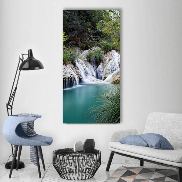 Natural Forest Waterfall Vertical Canvas Wall Art in gray, green and blue, single vertical panel hung on a wall