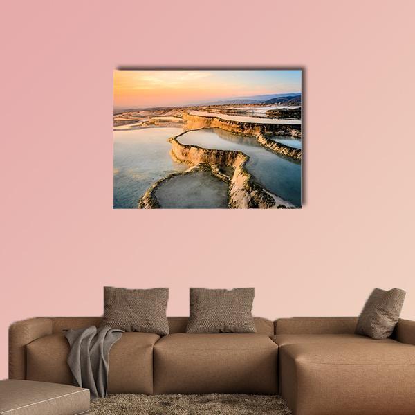 Natural Pools at Sunset Canvas Wall Art in brown, orange and blue, single panel hung on a wall