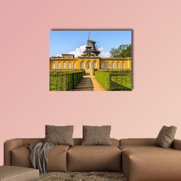 Potsdam Garden Path and Windmill Canvas Wall Art in yellow, green and blue, single panel hung on a wall