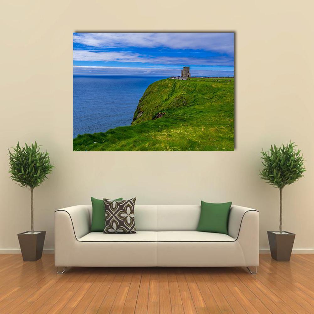 Cliffs of Moher with Stone Tower Canvas Wall Art in green and blue, single panel hung on a wall