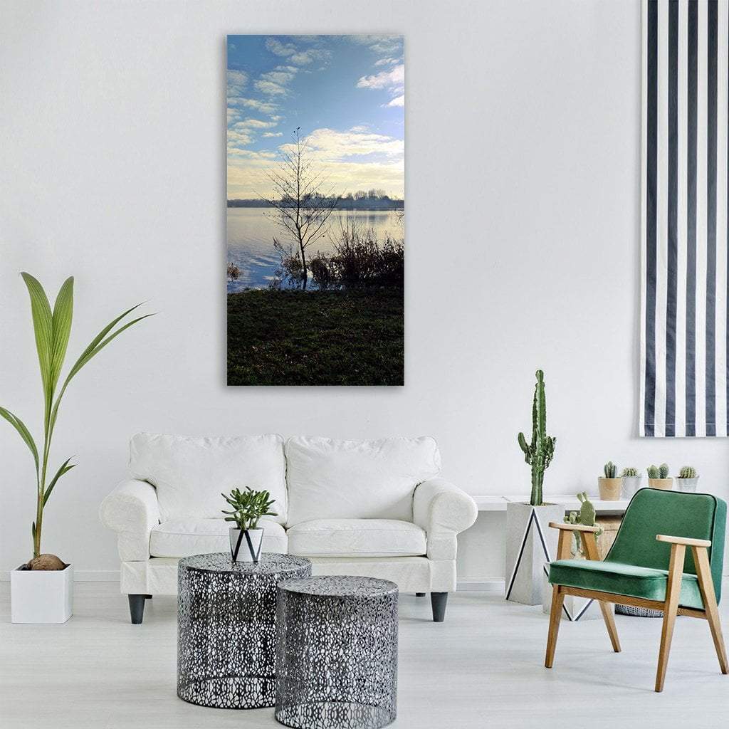 Leafless Tree by Calm Lake Vertical Canvas Wall Art in black, white and blue, single vertical panel hung on a wall