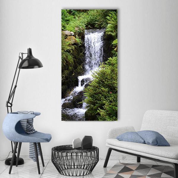 Lush Forest Waterfall Vertical Canvas Wall Art in white, gray and green, single vertical panel hung on a wall