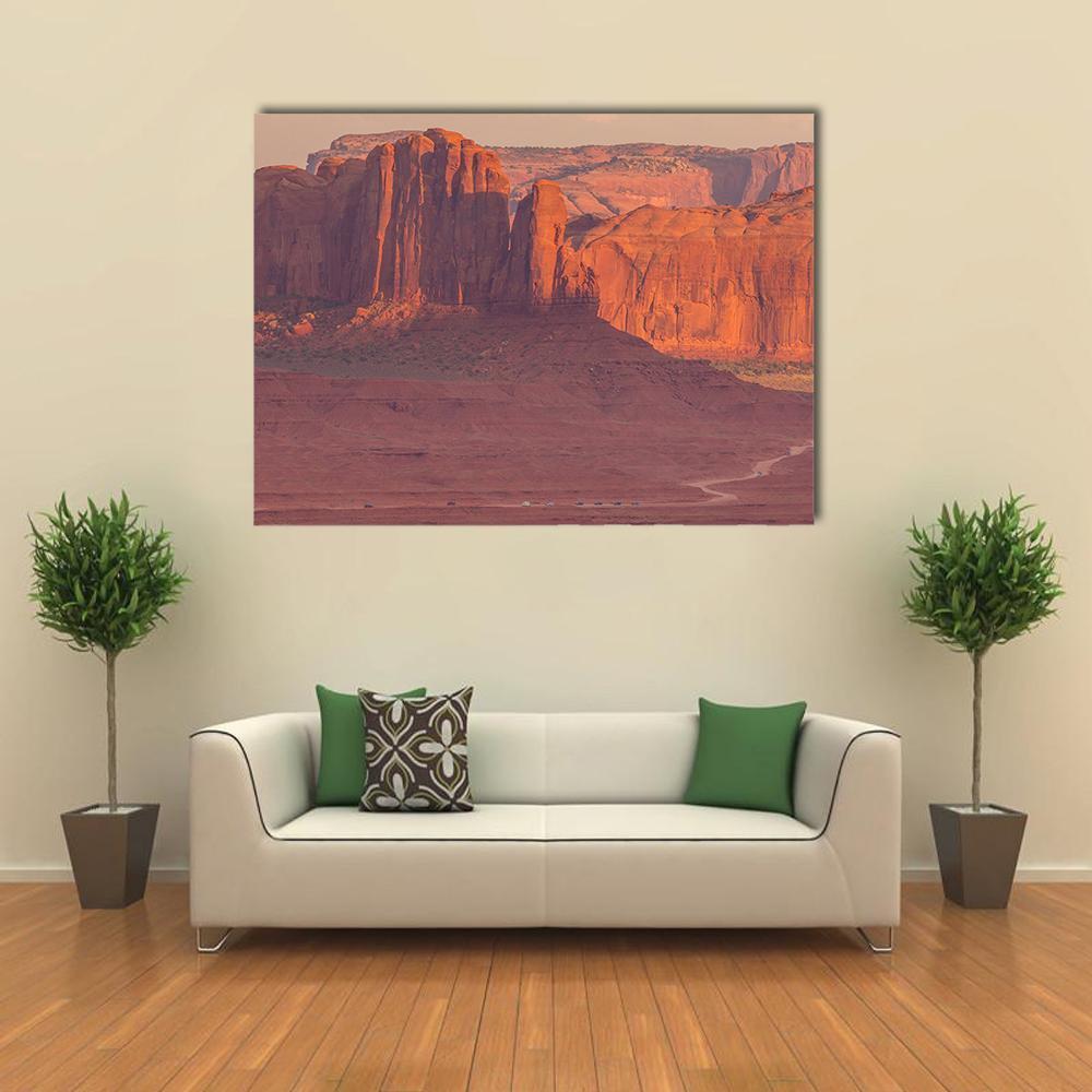 Monument Valley Buttes in Warm Light Canvas Wall Art in brown, red and orange, single panel hung on a wall