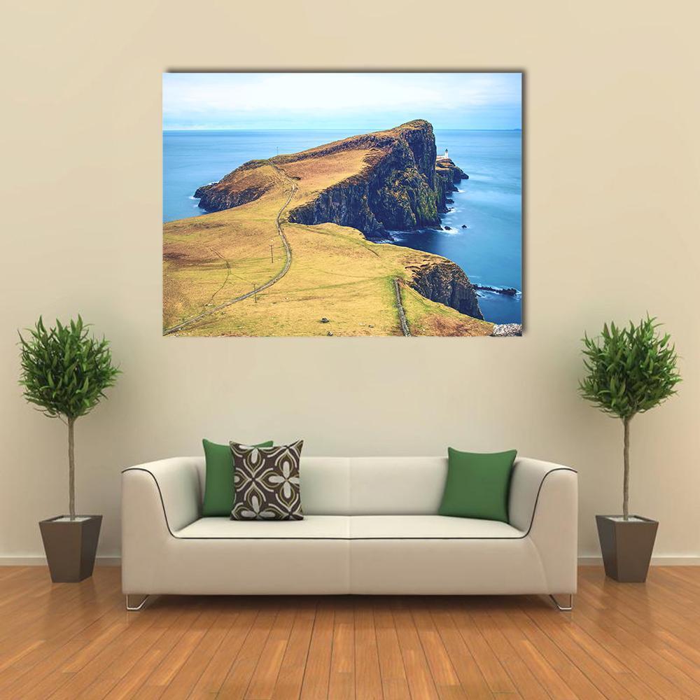 Neist Point Lighthouse on Coastal Cliffs Canvas Wall Art in yellow, green and blue, single panel hung on a wall