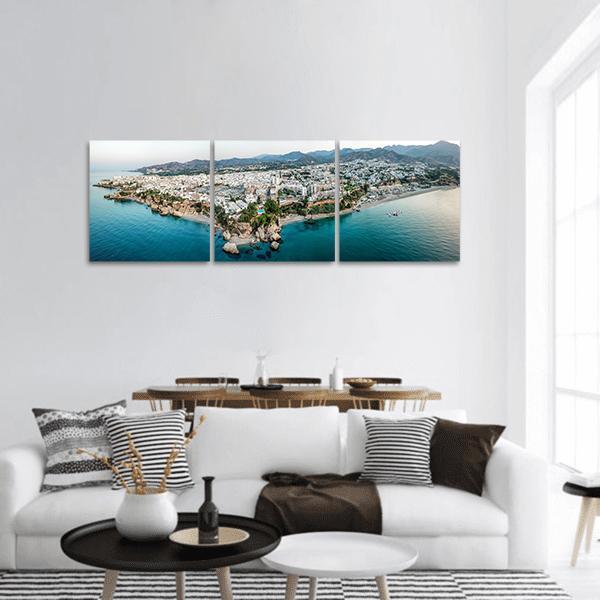 Nerja Coastal Town Aerial View Panoramic Canvas Wall Art in white, gray and blue, hung on a wall