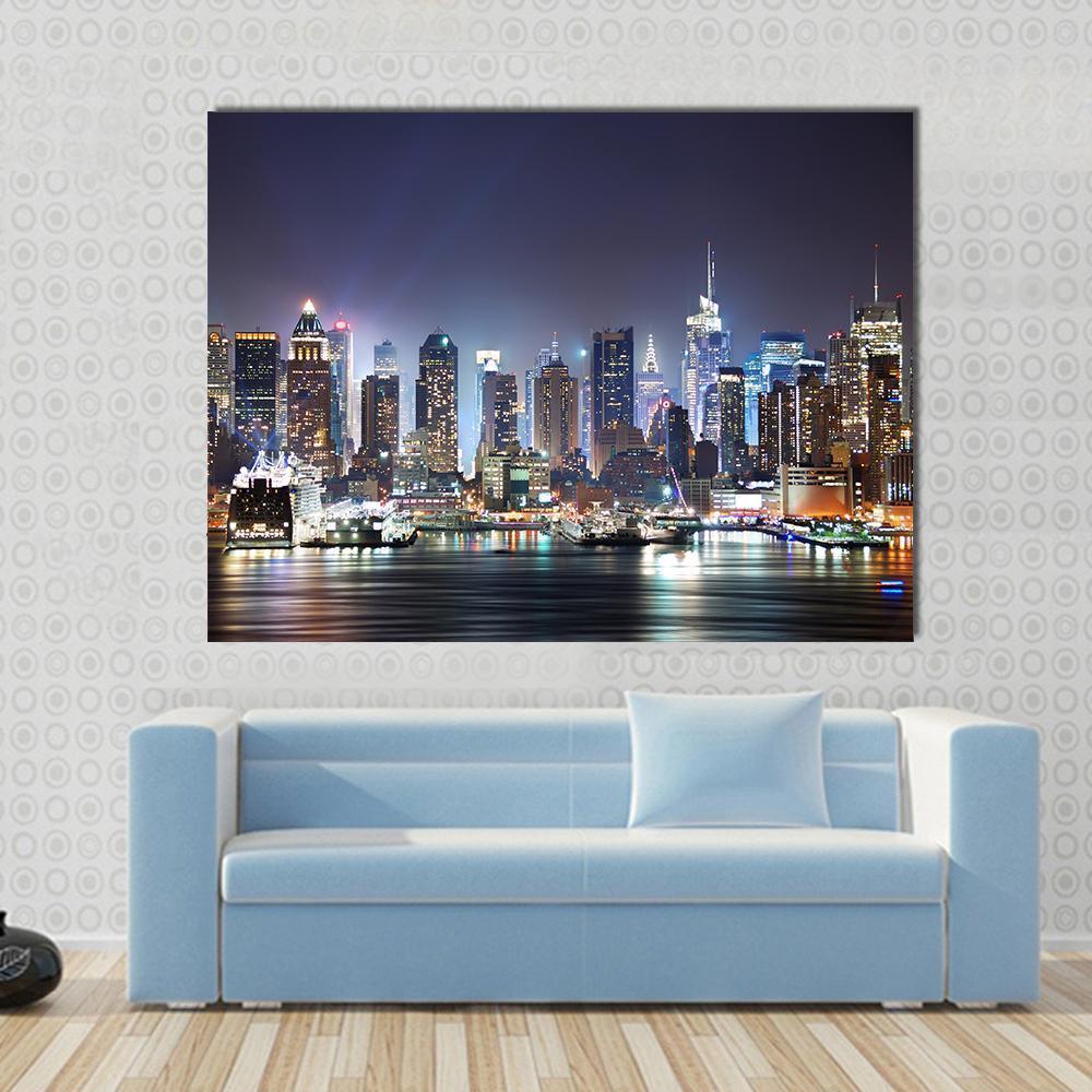 New York at Night Canvas Wall Art in black, yellow and blue, single panel hung on a wall