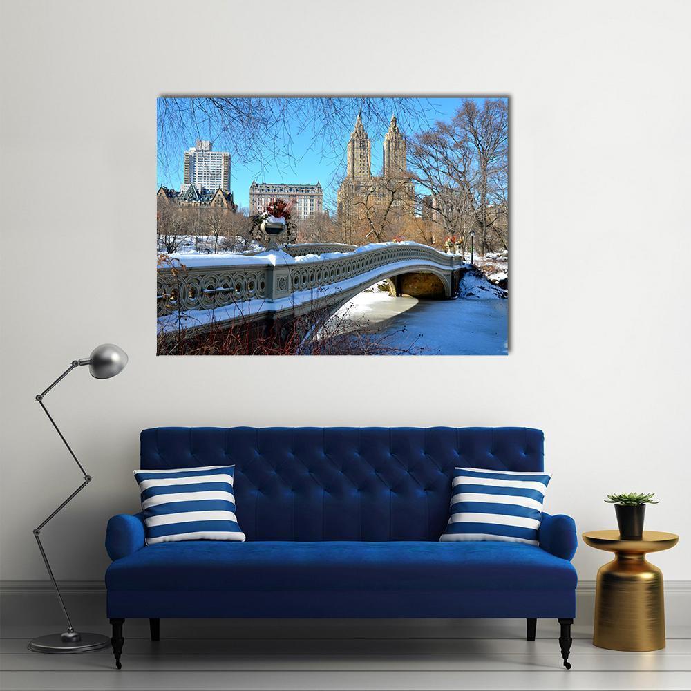 Bow Bridge in Winter Scene Canvas Wall Art in white, brown and blue, single panel hung on a wall