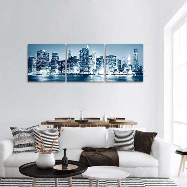 New York Night Skyline Panoramic Canvas Wall Art in white, blue and navy, hung on a wall