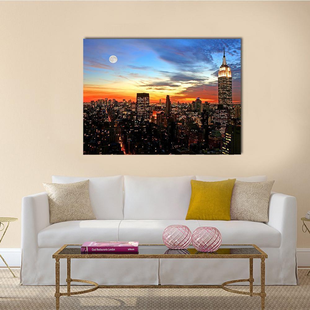New York Midtown Skyline at Night Canvas Wall Art in black, orange and blue, single panel hung on a wall
