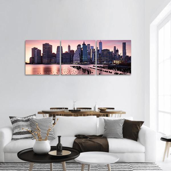 New York Skyline with One World Trade Center Panoramic Canvas Wall Art in blue, purple and pink, hung on a wall