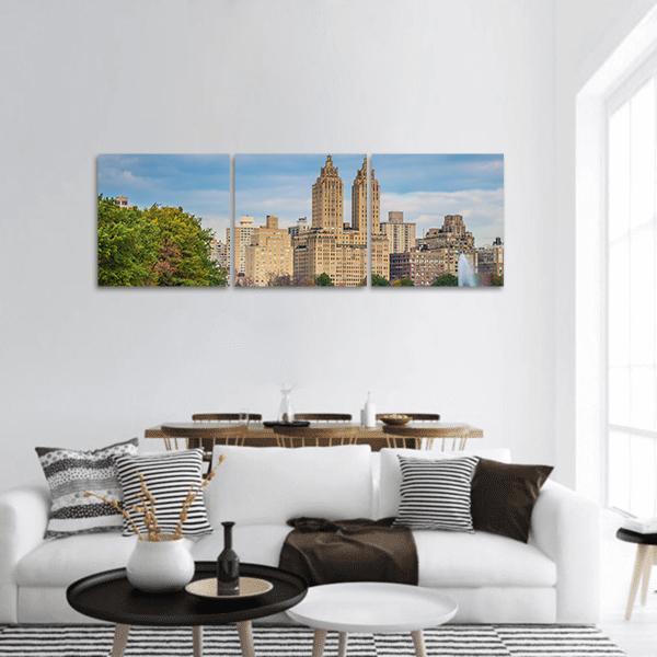 New York Skyline Over Central Park Panoramic Canvas Wall Art in beige, green and blue, hung on a wall