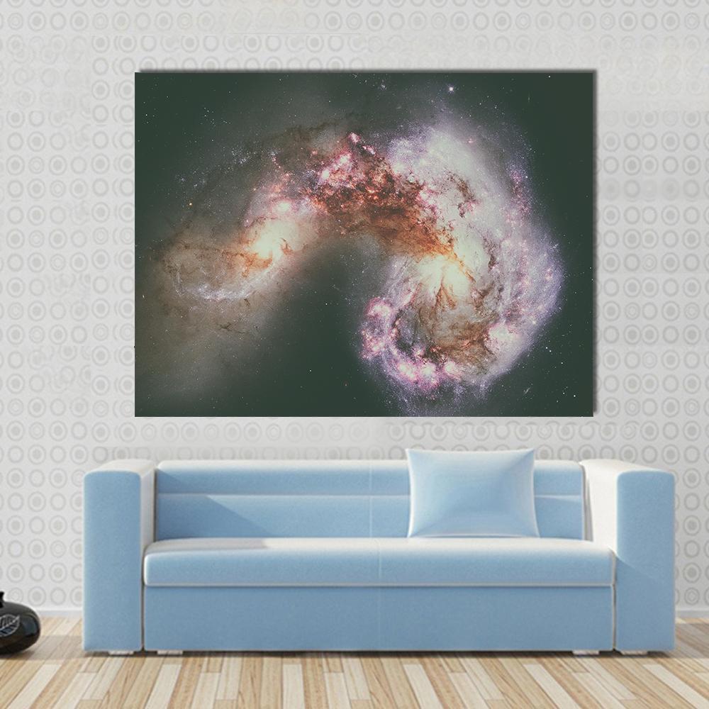 The Antennae Galaxies Canvas Wall Art in black, purple and pink, single panel hung on a wall