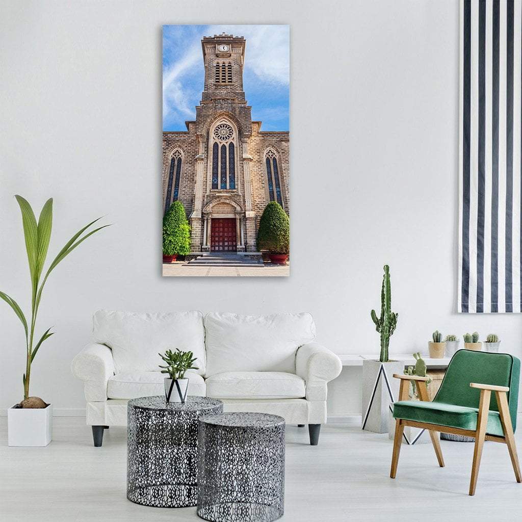 Nha Trang Cathedral Facade with Rose Window Vertical Canvas Wall Art in gray, brown and blue, single vertical panel hung on a wall