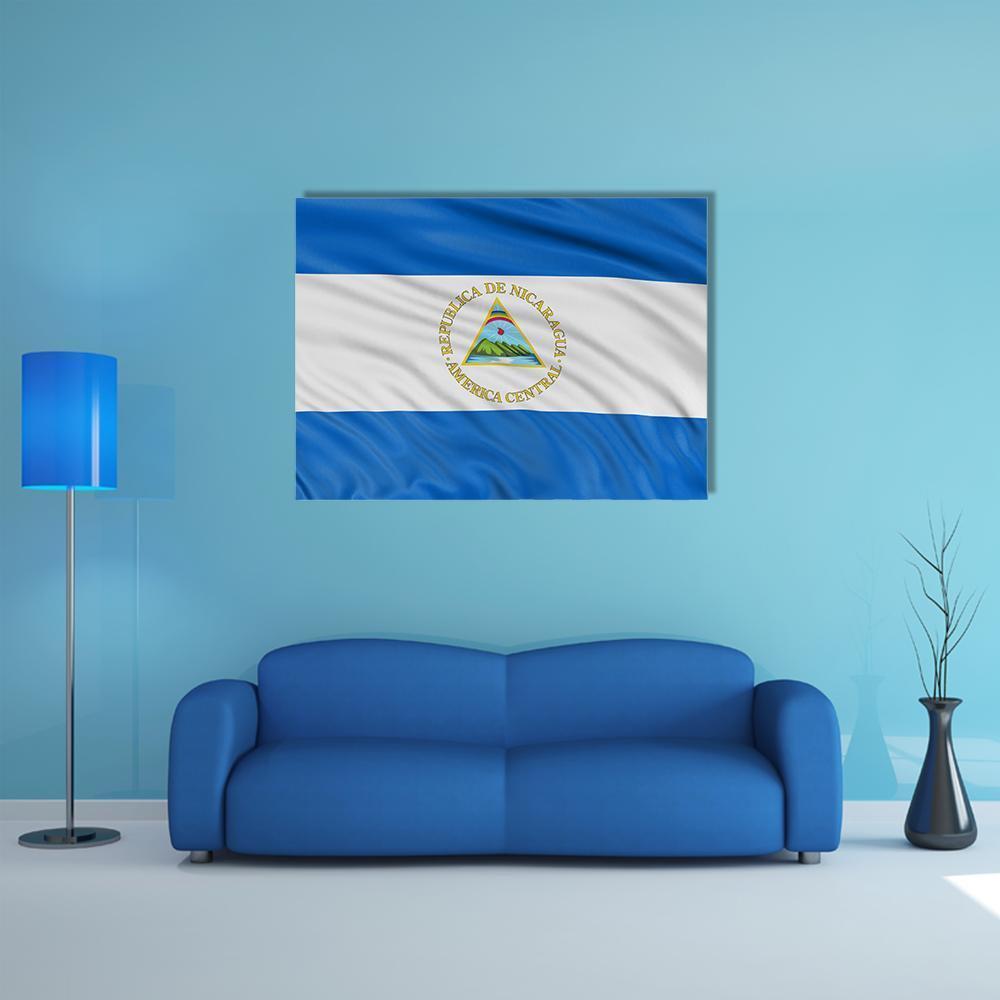 Waving Nicaragua Flag Canvas Wall Art in white and blue, single panel hung on a wall