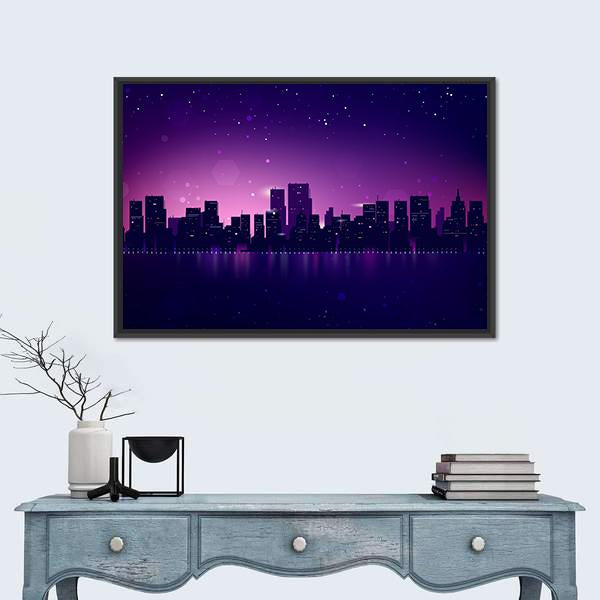 Night City Skyline with Waterfront Glow Canvas Wall Art in blue, purple and pink, framed canvas, product view on a white background