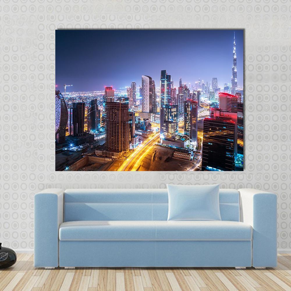 Night Cityscape of Dubai Canvas Wall Art in yellow, blue and navy, single panel hung on a wall