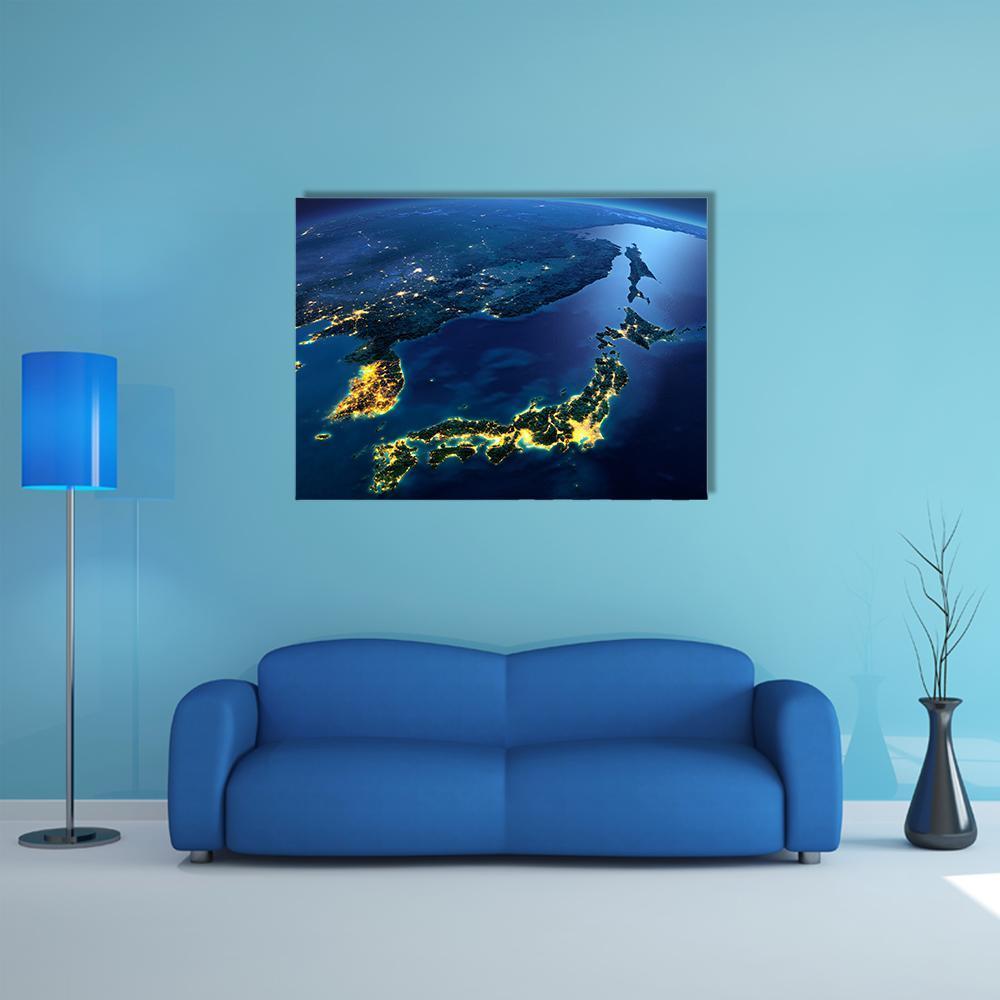 Earth at Night Over Japan and Korea Canvas Wall Art in black, yellow and blue, single panel hung on a wall