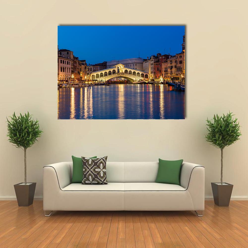 Rialto Bridge at Night Canvas Wall Art in gold, yellow and blue, single panel hung on a wall