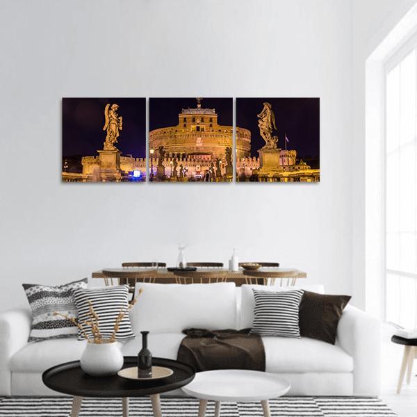 Castel Sant'angelo Rome at Night Panoramic Canvas Wall Art in black, gold and yellow, hung on a wall