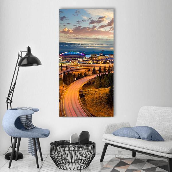 Seattle Night Skyline with Light Trails Vertical Canvas Wall Art in orange, yellow and blue, single vertical panel hung on a wall