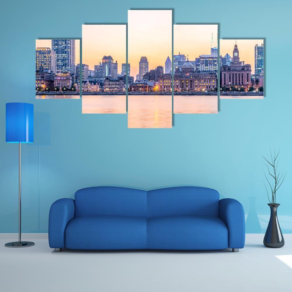 The Bund Shanghai Twilight Skyline Canvas Wall Art in orange, blue and pink, 5 panel Star layout hung on a wall