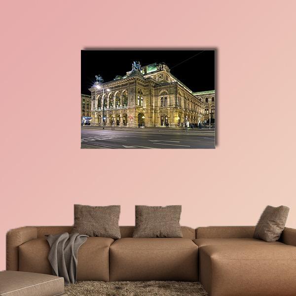 Night View of Vienna State Opera Canvas Wall Art in black, gold and yellow, single panel hung on a wall