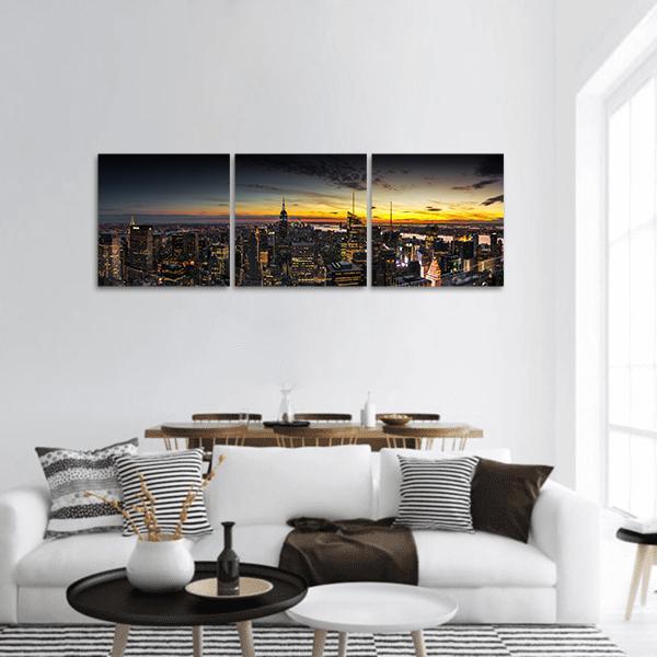 Manhattan Skyline at Sunset Panoramic Canvas Wall Art in black, orange and yellow, hung on a wall