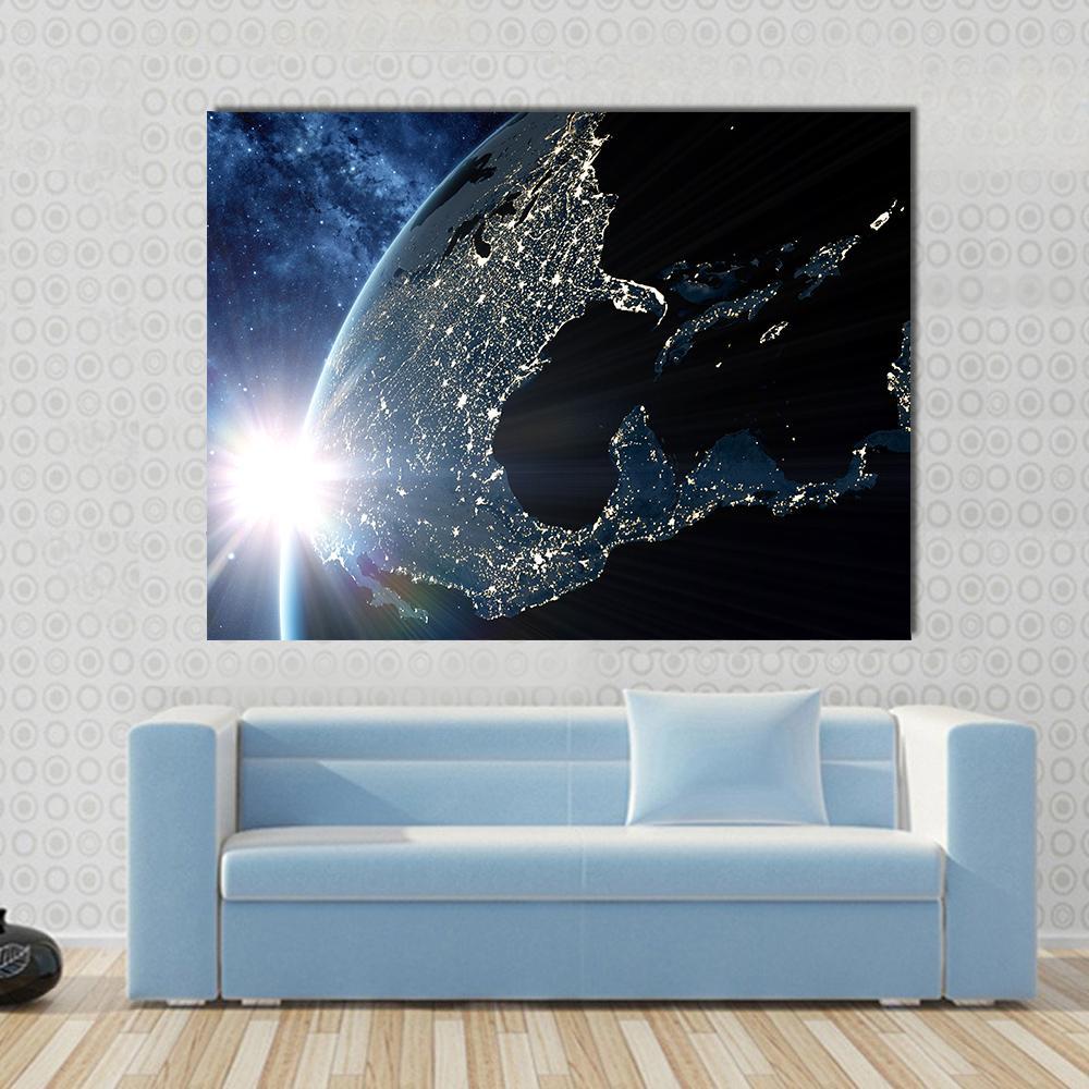 Earth at Night from Space Canvas Wall Art in black, gold and blue, single panel hung on a wall