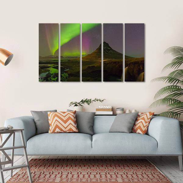 Northern Lights Over Kirkjufell Canvas Wall Art in black, green and purple, hung on a wall