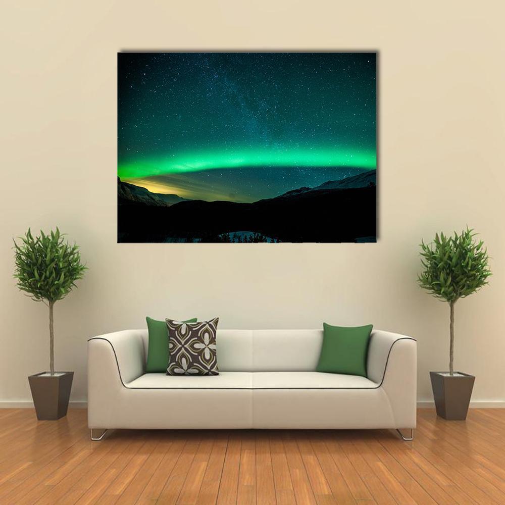 Northern Lights with the Milky Way Canvas Wall Art in black, green and blue, single panel hung on a wall