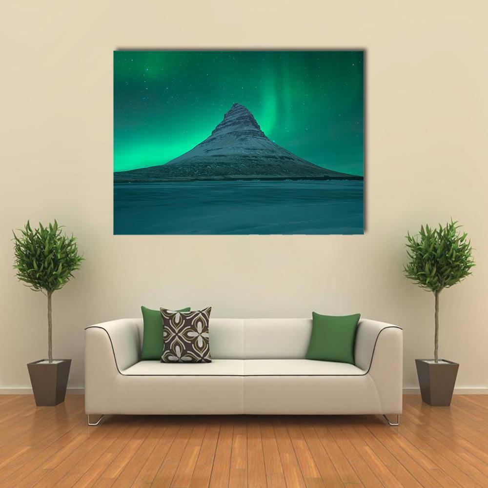 Aurora Over Kirkjufell Canvas Wall Art in green and blue, single panel hung on a wall