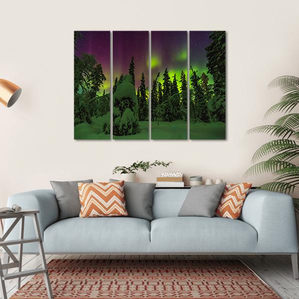 Lapland Northern Lights Over Snowy Forest Canvas Wall Art in black, green and purple, hung on a wall
