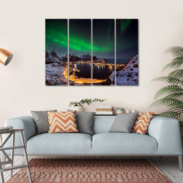 Northern Lights Over Reine Canvas Wall Art in black, green and blue, hung on a wall