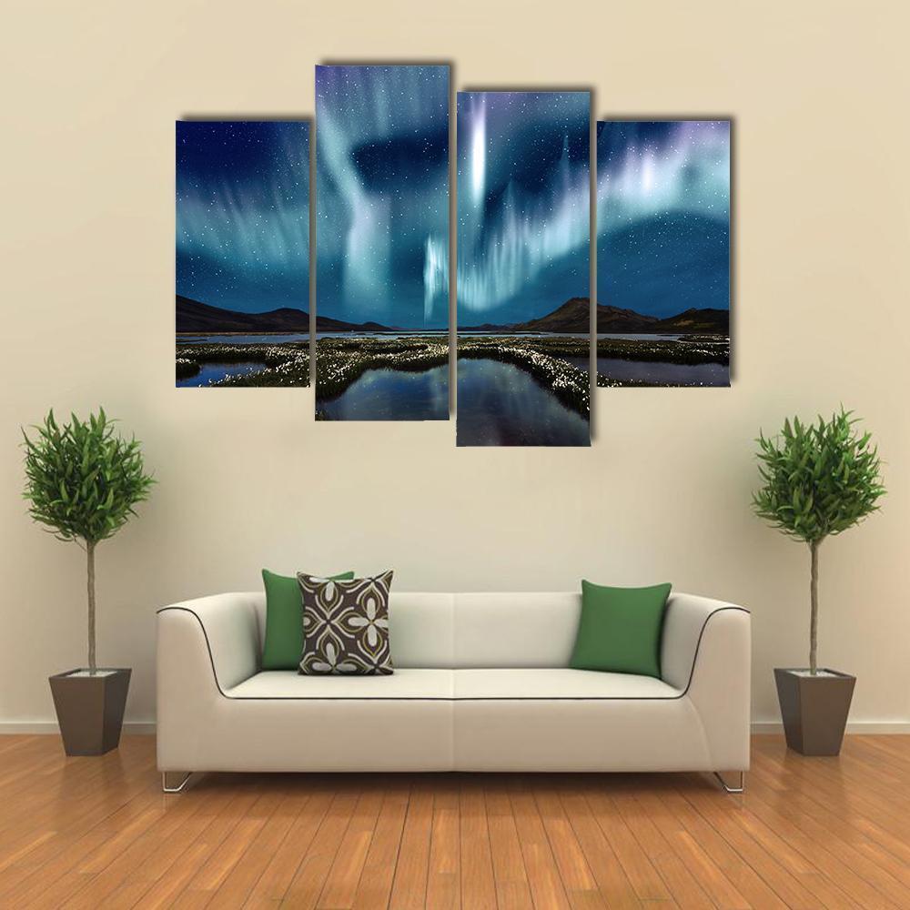 Northern Lights Over Wildflowers Canvas Wall Art in green, blue and purple, single panel hung on a wall