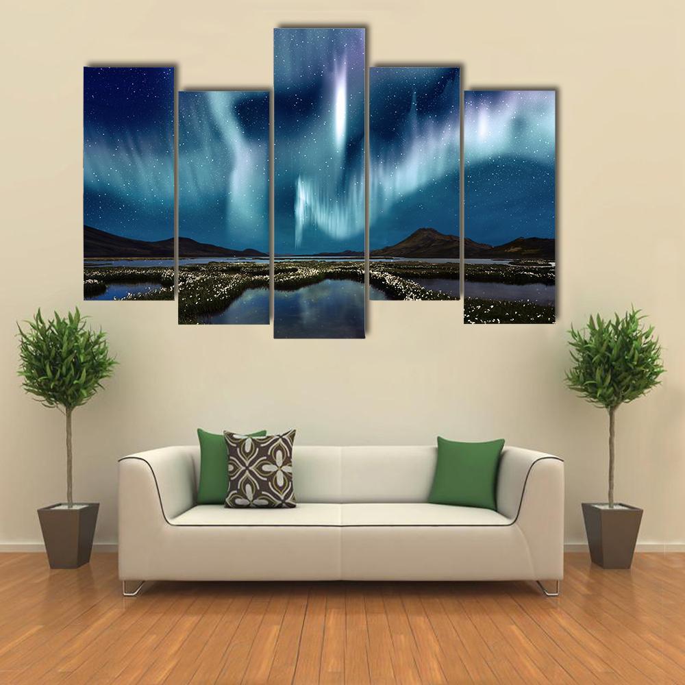 Northern Lights Over Wildflowers Canvas Wall Art in green, blue and purple, single panel hung on a wall