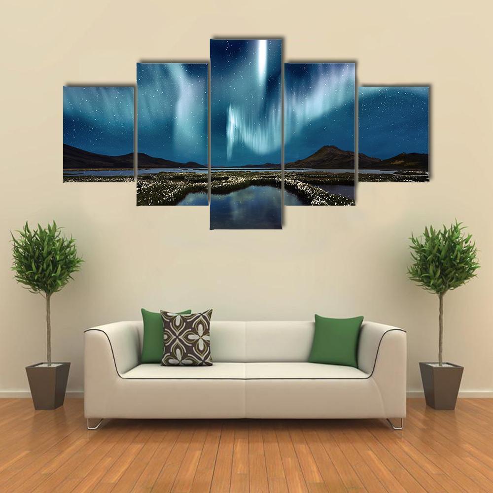 Northern Lights Over Wildflowers Canvas Wall Art in green, blue and purple, single panel hung on a wall