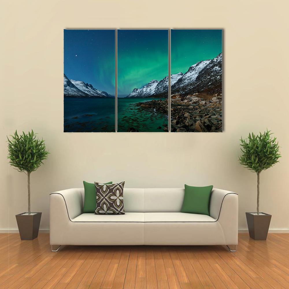 Aurora Borealis Over Fjords Canvas Wall Art in black, green and blue, 5 panel Pop layout hung on a wall