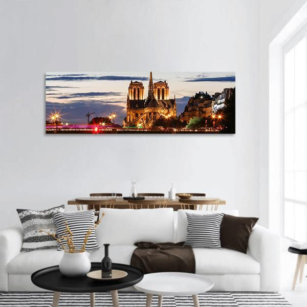 Notre Dame Cathedral at Twilight, Paris Panoramic Canvas Wall Art in black, yellow and blue, single panel hung on a wall
