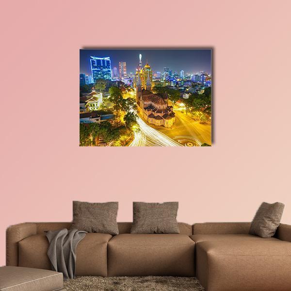 Notre Dame Cathedral at Night Canvas Wall Art in gold, yellow and blue, single panel hung on a wall