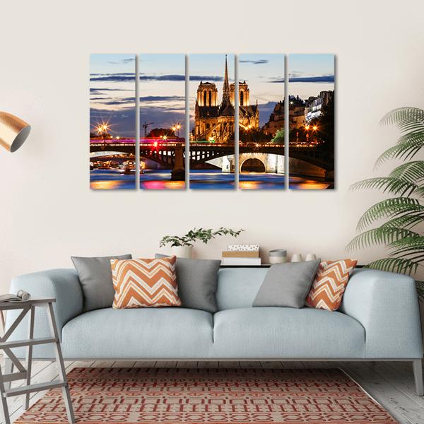 Notre Dame Cathedral Paris at Dusk Canvas Wall Art in gold, orange and blue, single panel hung on a wall