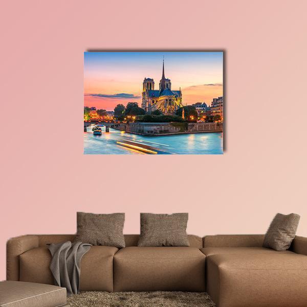 Notre-dame Cathedral at Dusk Canvas Wall Art in orange, yellow and blue, hung on a wall