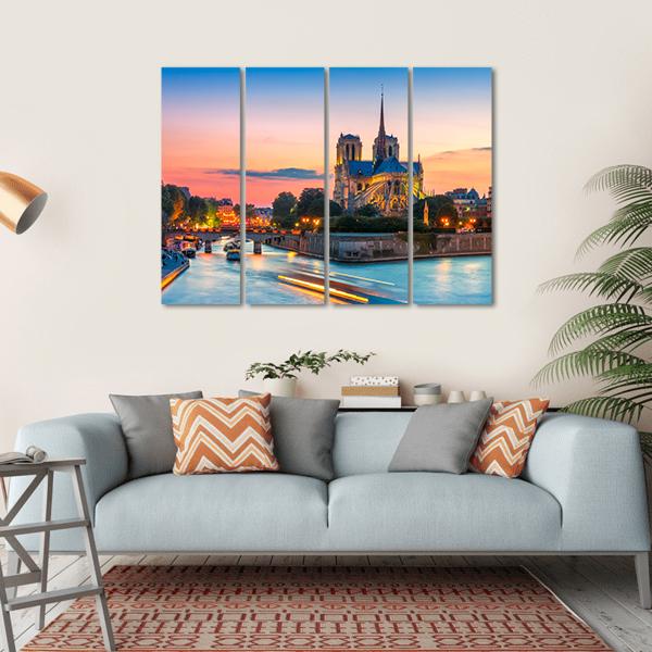 Notre-dame Cathedral at Dusk Canvas Wall Art in orange, yellow and blue, hung on a wall