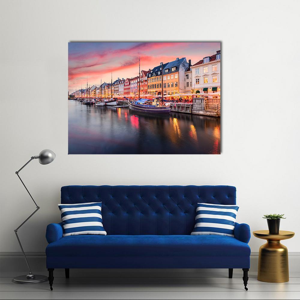 Nyhavn Canal Sunset Reflections Canvas Wall Art in orange, blue and pink, single panel hung on a wall