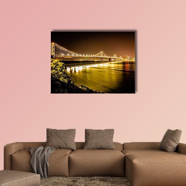 Oakland Bay Bridge at Night Canvas Wall Art in black, gold and yellow, single panel hung on a wall
